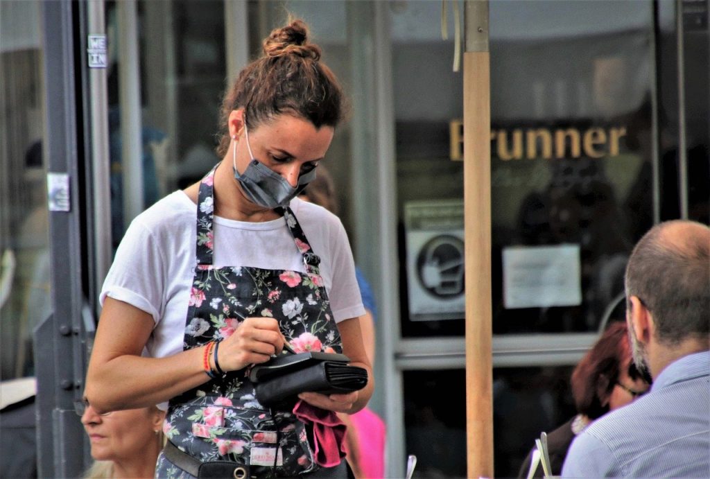 UK economy rebounds as Covid restrictions ease - Restaurant waitress